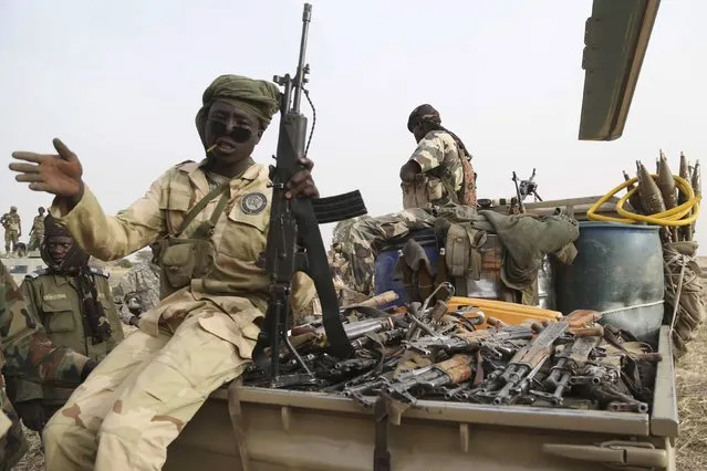 Chadian soldiers carry weapons captured from Boko Haram in a pickup truck in the recently retaken town of Damasak, Nigeria, March 18, 2015. Armies from Nigeria, Cameroon, Chad and Niger have launched an offensive to end Boko Haram's six-year campaign, which has killed thousands in northern Nigeria and spilled over into Cameroon and Niger. (Photo by Emmanuel Braun/Reuters)