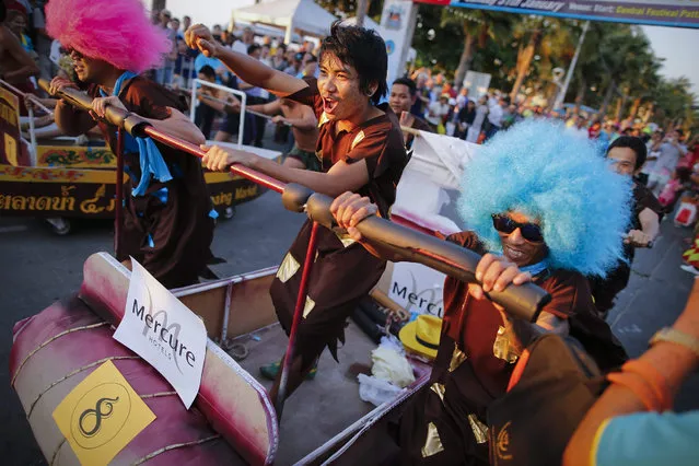 Participants run with their customized beds during the Pattaya Bed Race 2016, in Pattaya, Thailand, 31 January 2016. The annual festival, now in its eighth edition, saw teams from business in Pattaya taking part in the race, whilst proceeds from entry fees paid by bars, hotels and other businesses joining the race will go to a local charity caring for orphans. (Photo by Diego Azubel/EPA)
