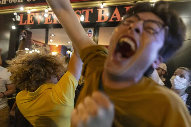 Fans react as the French team play against Germany in their first game of the EURO 2021 tournament, on June 15, 2021 in Paris, France. As France's Covid-19 night-time curfew remains, politicians requested leniency from police during France's first game in the EURO 2020 football tournament. However, gatherings must be confined to fan zones, which still remain few in numbers. (Photo by Sam Tarling/Getty Images)