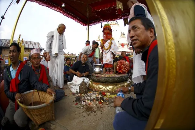 An idol of Rato Machhindranath is placed at the centre of a courtyard while the priests perform religious ritual at Bungamati in Lalitpur April 5, 2015. (Photo by Navesh Chitrakar/Reuters)