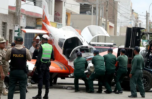 A small Peruvian Air Force plane is seen after it crashed onto a street in Lima, Peru on February 4, 2019. (Photo by Guadalupe Pardo/Reuters)