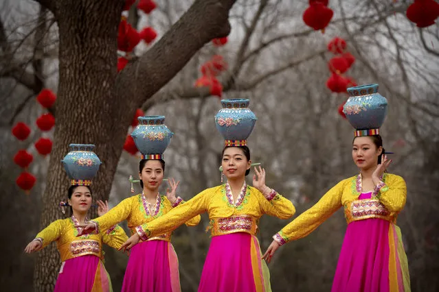 Dancers in traditional ethnic clothing perform at a temple fair at Longtan Park in Beijing, Wednesday, February 6, 2019. Chinese people are celebrating the second day of the Lunar New Year on Tuesday, the Year of the Pig on the Chinese zodiac. (Photo by Mark Schiefelbein/AP Photo)