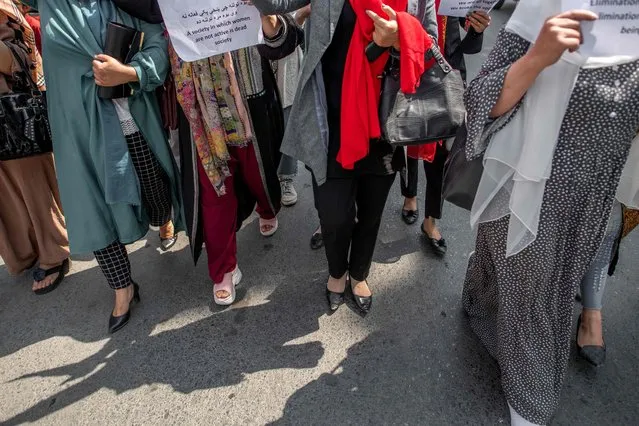 Afghan women take part in a demonstration demanding better rights for women in front of the former Ministry of Women Affairs in Kabul on September 19, 2021. (Photo by Bulent Kilic/AFP Photo)