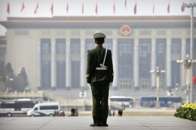 A Chinese paramilitary policeman stands guard while facing the Great Hall of the People, the meeting place of China's national legislature, in Beijing, Friday, March 1, 2019. Thousands of delegates from around China are gathering in Beijing for next week's annual session of the country's rubber-stamp legislature and its advisory body. (Photo by Mark Schiefelbein/AP Photo)