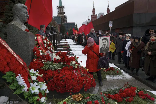 A Communist party supporter cries while placing flowers on Stalin's grave in Red Square, outside the Kremlin wall, to mark the 63th anniversary of his death in Moscow, Russia, on Saturday, March 5, 2016. Josef Stalin led the Soviet Union from 1924 until his death in 1953. (Photo by Ivan Sekretarev/AP Photo)