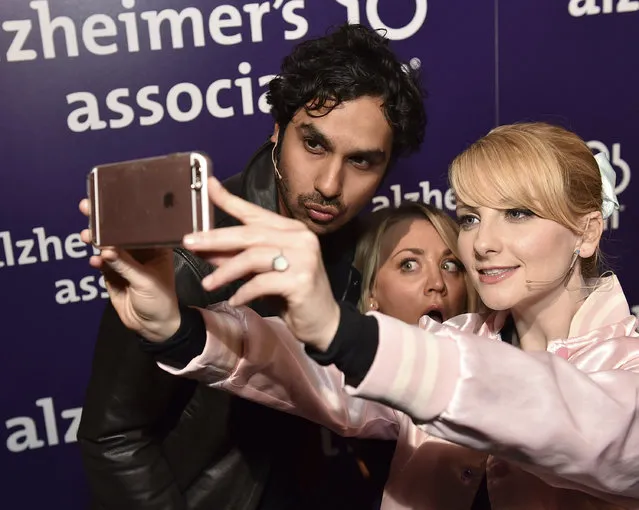 Kunal Nayyar, from left, Kaley Cuoco and Melissa Rauch take a selfie backstage at the 24th annual Alzheimer's Association "A Night at Sardi's" at the Beverly Hilton hotel on Wednesday, March 9, 2016, in Beverly Hills, Calif. (Photo by Jordan Strauss/Invision for Alzheimer's Association/AP Images)