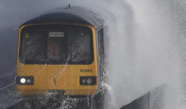 Waves hit a train during heavy seas and high winds in Dawlish in south west Britain, February 2, 2017. (Photo by Toby Melville/Reuters)