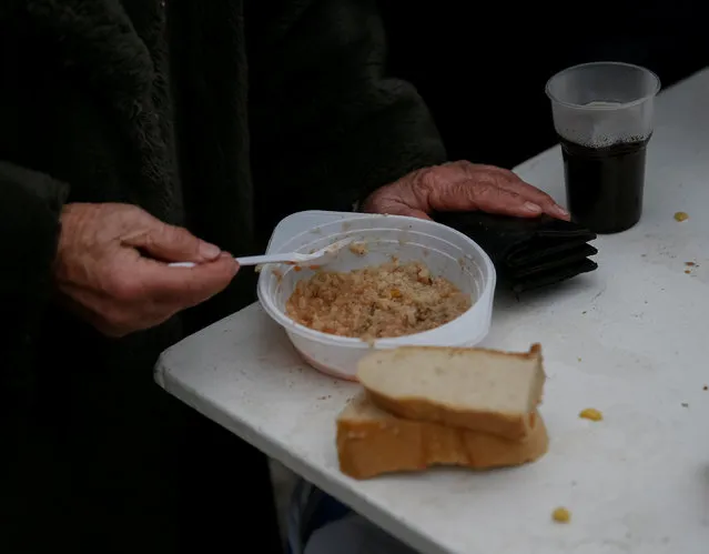 A local resident eats a meal at an emergency center after shelling hit supply infrastructure in the government-held industrial town of Avdiyivka, Ukraine, February 3, 2017. (Photo by Gleb Garanich/Reuters)