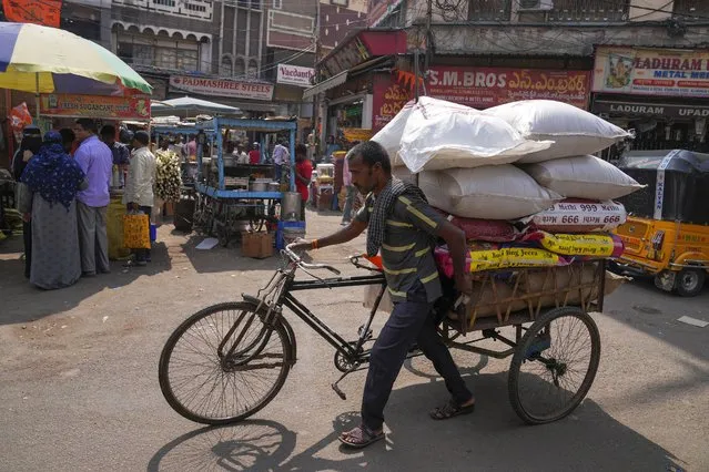 A rickshaw puller transports a load at a wholesale market in Hyderabad, India, Thursday, February 1, 2024. India’s finance minister unveiled on Thursday a short-term budget to meet government expenditures until national elections are held by May. (Photo by Mahesh Kumar A./AP Photo)