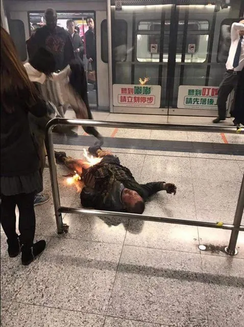 A man, whom police believe to have set himself alight, is seen inside a subway station in Hong Kong, China February 10, 2017. At least 17 people have been injured in a fire attack on a packed passenger train in Hong Kong. It occurred during the busy rush hour at the Tsim Sha Tsui station. Hong Kong's counter-terror units were deployed to the scene, but there were conflicting reports on how the blaze started. Public broadcaster RTHK reported the suspect, surnamed Cheung, had said nothing and tried to set himself on fire using flammable liquid. (Photo by Reuters/Social Media/@GastronomicNerd)