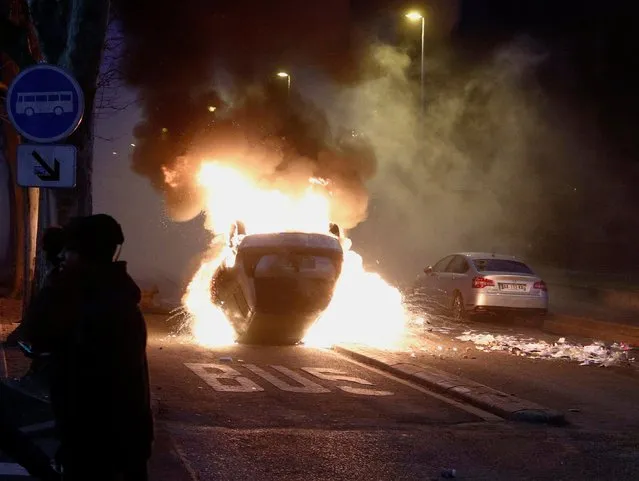 A car burns as protesters clash with French riot police in Bobigny, a suburb of Paris, France, 11 February 2017, after attending a demonstration in support of Theo, a young man who was hospitalised for an emergency surgery after he was allegedly sodomized with a truncheon during a police check. The incident sparked violent protests in the Paris suburb, one police officer is now charged with rape. (Photo by Yoan Valat/EPA)