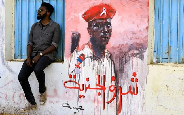 A Sudanese youth takes rest near a revolutionary mural reading in arabic 'the honor of a soldier', in a street of Khartoum, Sudan, 23 April 2019. Sudanese protesters continue their sit in and gatherings near the army head quarters in a bid to pressure for a civilian council instead of the current military one, after the resignation of President Omar al-Bashir on 11 April. Some 50 protesters were killed since December 2018 when the protesters asking for a change of regime started. (Photo by EPA/EFE/Rex Features/Shutterstock/Stringer)
