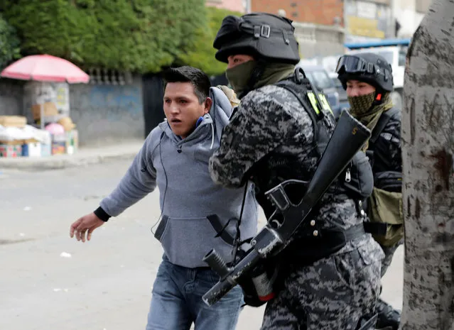 A coca grower from Yungas is arrested by riot policemen during clashes in La Paz, Bolivia February 21, 2017. (Photo by David Mercado/Reuters)