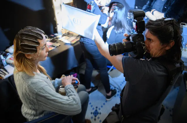 Photographer Ian Gavan works with models backstage, ahead of a presentation by Haluminous at the Fashion Scout venue during London Fashion Week on February 19, 2017 in London, England. (Photo by Leon Neal/Getty Images)