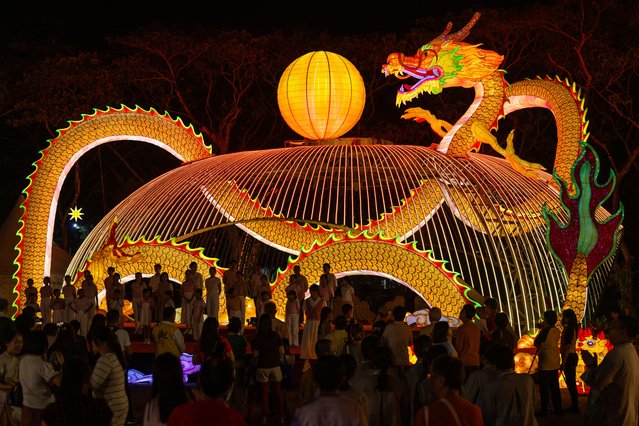 People visit a dragon lantern decoration with energy-saving LED lights ahead of the lunar new year at the Fo Guang Shan Dong Zen temple in Jenjarom, some 50 kilometres southwest of Kuala Lumpur on January 26, 2024. (Photo by Mohd Rasfan/AFP Photo)