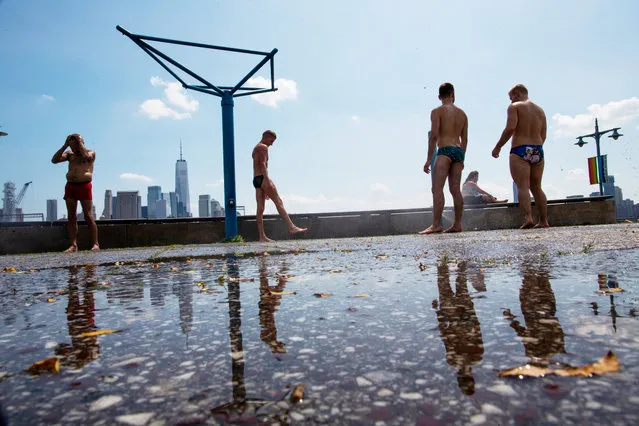People cool off at Pier 45 on Saturday, July 20, 2019 in New York. Temperatures in the high 90s are forecast for Saturday and Sunday with a heat index well over 100. Much of the nation is also dealing with high heat. (Photo by Eduardo Munoz Alvarez/AP Photo)