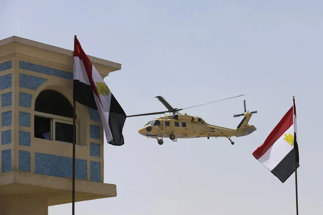 A helicopter carries Egyptian President Abdel-Fattah el-Sissi after the funeral of Prosecutor General Hisham Barakat, killed in a bomb attack a day earlier, outside the Field Marshal Mohammed Hussein Tantawi Mosque in Cairo, Egypt, Tuesday, June 30, 2015. Heavy security forces deployed across the Egyptian capital for the burial of Barakat, the top judicial official in charge of overseeing prosecution of thousands of Islamists. (Photo by Hassan Ammar/AP Photo)