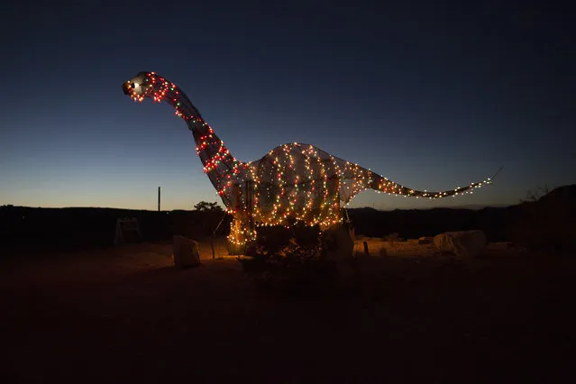 A dinosaur statue stands outside a store off the highway in Terlingua, Texas, near the US-Mexico border, Monday, March 27, 2017. (Photo by Rodrigo Abd/AP Photo)