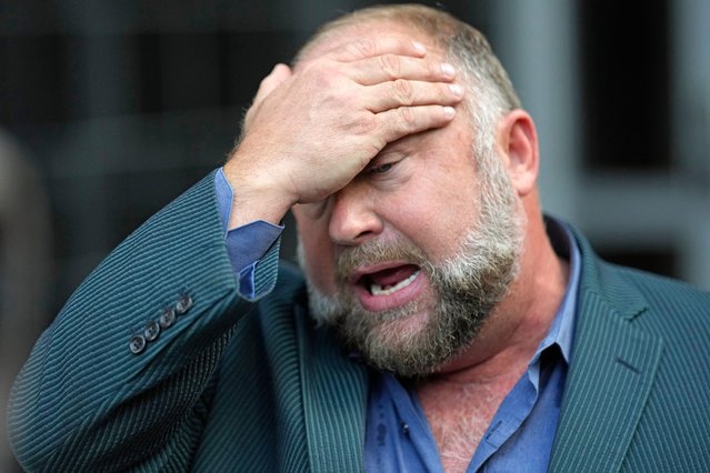 Right-wing conspiracy theorist Alex Jones wipes his forehead as he speaks to the media after arriving at the federal courthouse for a hearing in front of a bankruptcy judge Friday, June 14, 2024, in Houston. The judge is expected to rule on whether to liquidate Jones' assets to help pay the $1.5 billion he owes for his false claims that the Sandy Hook Elementary School shooting was a hoax. (Photo by David J. Phillip/AP Photo)