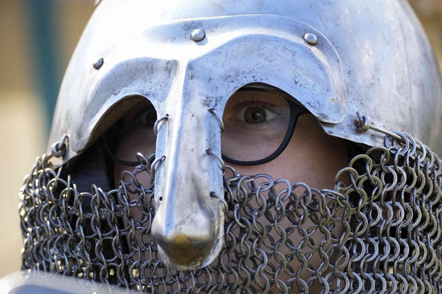 A boy wears a medieval helmet during a festival dedicated to the Day of Russia in St. Petersburg, Russia, Wednesday, June 12, 2024. The Day of Russia is celebrated annually on 12 June. (Photo by Dmitri Lovetsky/AP Photo)