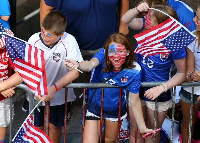 A young fan cheers while waiting for the ticker tape parade to celebrate the U.S. women's soccer team World Cup victory, Friday, July 10, 2015, in New York. (Photo by Adam Hunger/AP Photo)