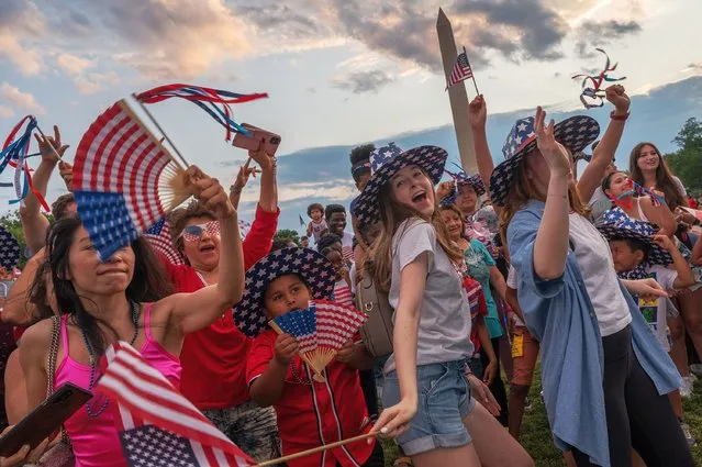 Independence Day revelers cheer and celebrate on the National Mall in Washington, DC, on Independence Day, July 04, 2021. (Photo by Craig Hudson for The Washington Post)