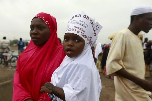 A mother and her daughter are seen after prayers at the Abuja praying ground on the first day of the Muslim holiday of Eid-al-Fitr, marking the end of the holy month of Ramadan in Abuja, Nigeria's capital, July 17, 2015. (Photo by Afolabi Sotunde/Reuters)