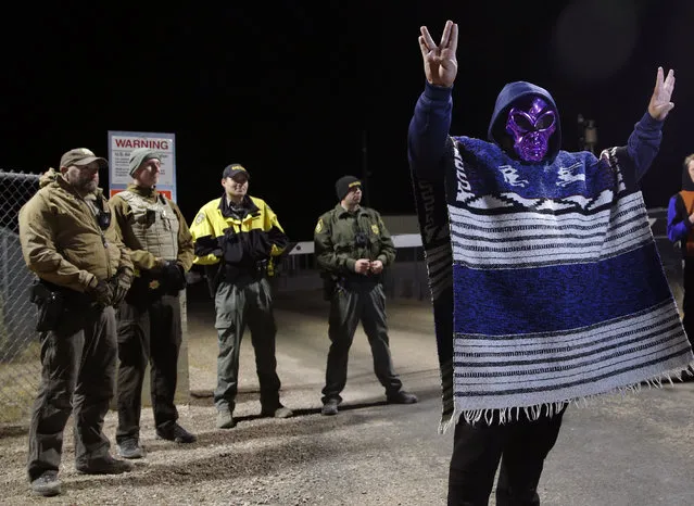 A man in an alien mask stands at an entrance to the Nevada Test and Training Range near Area 51 September 20, 2019, outside of Rachel, Nev. People gathered at the gate inspired by the “Storm Area 51” internet hoax.  (Photo by John Locher/AP Photo)