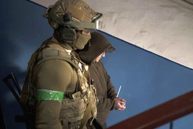 A Security Service of Ukraine (SBU) serviceman detains a man suspected to be a Russian collaborator in Kharkiv, Ukraine, Thursday, April 14, 2022. (Photo by Felipe Dana/AP Photo)
