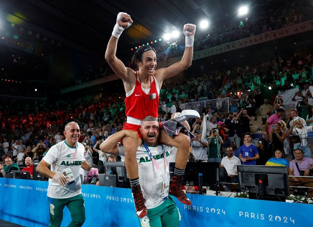 Algeria's Imane Khelif celebrates after beating China's Yang Liu (Blue) in the women's 66kg final boxing match during the Paris 2024 Olympic Games at the Roland-Garros Stadium, in Paris on August 9, 2024. (Photo by Peter Cziborra/Reuters)