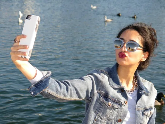 Female tourist taking a selfie with her mobile phone, Washington DC, USA. (Photo by Hisham Ibrahim/Getty Images)