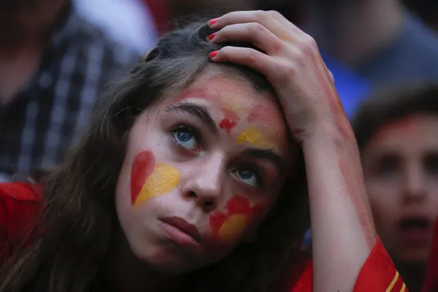 A Spain supporter reacts as she watches the team's 2014 World Cup Group B soccer match against Netherlands on a giant screen at a fan park in Madrid, June 13, 2014. (Photo by Juan Medina/Reuters)