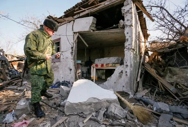 A serviceman of self-proclaimed Donetsk People's Republic examines a household, which locals said was damaged during recent shelling, outside rebel-held Horlivka, north of Donetsk, Ukraine, November 6, 2019. (Photo by Alexander Ermochenko/Reuters)