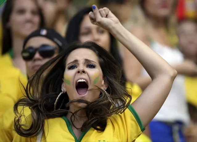 A Brazilian supporter reacts before the start of the World Cup quarterfinal soccer match between Brazil and Colombia at the Arena Castelao in Fortaleza, Brazil, Friday, July 4, 2014. (Photo by Felipe Dana/AP Photo)