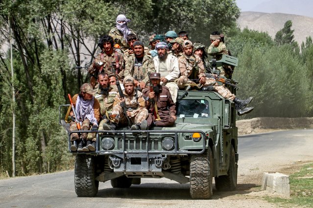 Armed Taliban security personnel sit atop a humvee armored vehicle, as they ride along a street in Khash district, Badakhshan province on September 1, 2024. (Photo by Omer Abrar/AFP Photo)