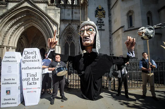 Supporters from the group Distant Voices, who oppose the liberalisation of euthanasia laws, demonstrate with a giant puppet of a judge outside the Royal Courts of Justice, Strand on July 17, 2017 in London, England. Noel Conway, 67, who is terminally ill with motor neurone disease, is seeking a legal challenge on the law banning assisted dying. (Photo by Jack Taylor/Getty Images)