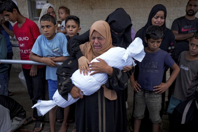 Palestinians mourn relatives killed in the Israeli bombardment of the Gaza Strip, at a hospital in Deir al-Balah, Tuesday, October 1, 2024. (Photo by Abdel Kareem Hana/AP Photo)