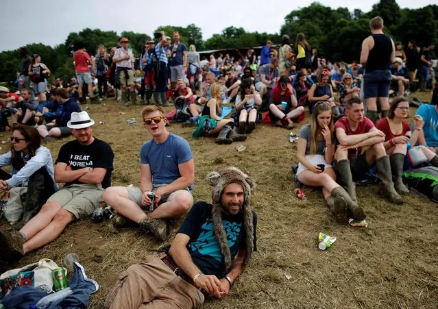 Revellers rest in a field during the Glastonbury Festival at Worthy Farm in Somerset, Britain, June 23, 2016. (Photo by Stoyan Nenov/Reuters)