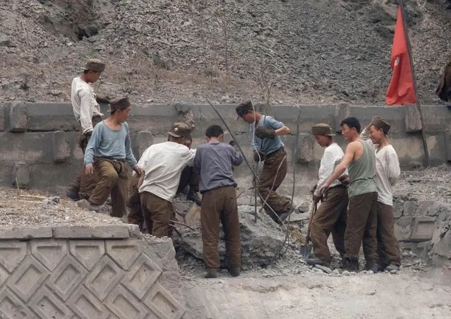 Workers on the highway were reparaing the road on the left side. (Photo by Eric Lafforgue/Exclusivepix Media)