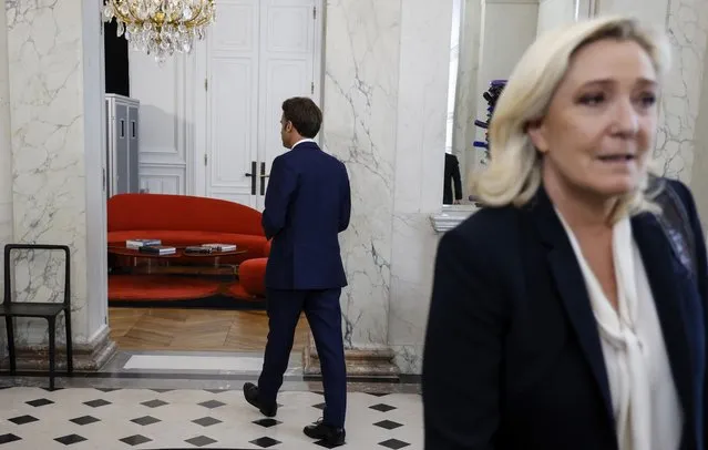 French President Emmanuel Macron, leaves, after a meeting with French far-right Rassemblement National (RN) leader and Member of Parliament Marine Le Pen at the Elysee Palace in Paris, France, Tuesday, June 21, 2022. French President Emmanuel Macron was holding talks Tuesday with France's main party leaders after his centrist alliance failed to win an absolute majority in parliamentary elections. (Photo by Ludovic Marin/Pool photo via AP Photo)
