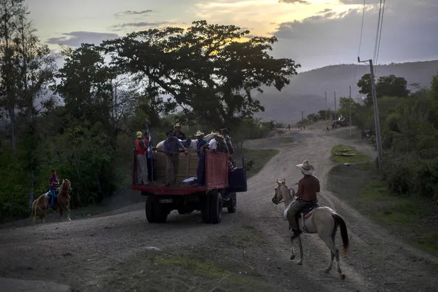 In this July 26, 2015 photo, horsemen take their horses back to a farm after a rodeo show in Santiago, Cuba. The city sits 500 miles (800 kilometers) east from Havana on highways that narrow outside the capital to roads of horsecarts, bicyclists and stray cows. (Photo by Ramon Espinosa/AP Photo)