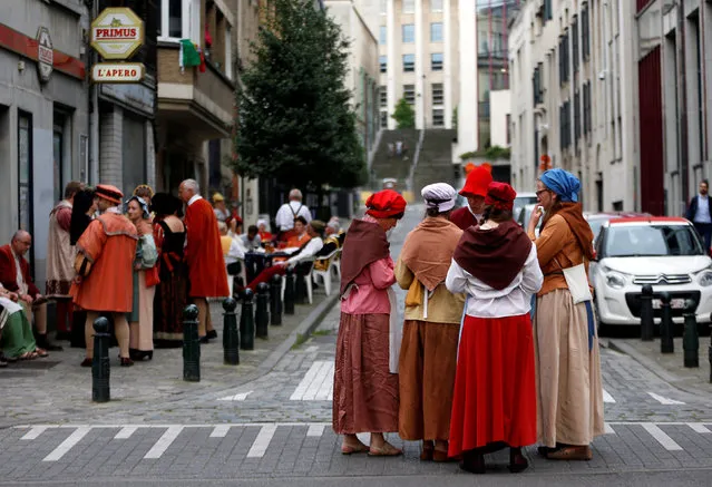 Volunteers wearing medieval costumes gather before taking part in an annual Renaissance pageant, the Ommegang parade, which commemorates the 16th century arrival of Habsburg Emperor Charles V, in central Brussels, Belgium, July 7, 2016. Picture taken July 7, 2016. (Photo by Francois Lenoir/Reuters)