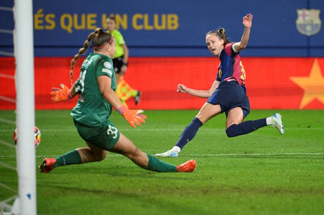 Barcelona's Norwegian forward #10 Caroline Graham Hansen scores her team's seventh goal in spite of St. Polten's goalkeeper #33 Carina Schluter during the UEFA Women's Champions League preliminary round 1 day 3 Group D football match between FC Barcelona and SKN St. Polten at the Estadi Johan Cruyff in Barcelona on November 12, 2024. (Photo by Josep Lago/AFP Photo)