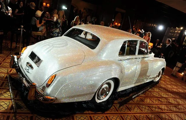 A Rolls Royce Silver Cloud from 1962, which has been adorned with countless Swarovski crystals, is pictured during a charity event at Hotel Vierjahreszeiten in Munich, Germany, 17 July 2012. It took three years to cover the Rolls Royce in about 1,000,000 Swarovski crystals. It is going to be auctioned in the next months in favour of the “Help in Motion” charity. (Photo by Tobias Hase)