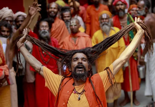 A Hindu holy man shouts religious slogans as he waits in a queue to register for an annual pilgrimage to the holy Amarnath cave, in Jammu, India, Tuesday, July 5,2016.Thousands of pilgrims annually visit the remote Himalayan shrine of Amarnath at 3,888 meters (12,756 feet) above sea level to worship an icy stalagmite representing Shiva, the Hindu god of destruction. (Photo by Channi Anand/AP Photo)
