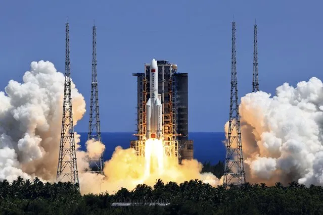 In this photo released by Xinhua News Agency, the Long March 5B Y3 carrier rocket, carrying Wentian lab module blasts off from the Wenchang Space Launch Center in Wenchang in southern China's Hainan Province Sunday, July 24, 2022. On a hot Sunday afternoon, with a large crowd of amateur photographers and space enthusiasts watching, China launched the Wentian lab module from tropical Hainan Island. (Photo by Li Gang/Xinhua via AP Photo)