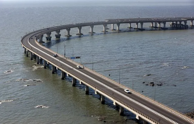 Cars move along the nearly empty Bandra-Worli sea link over the Arabian Sea after government imposed restrictions on public gatherings in attempts to prevent spread of coronavirus disease (COVID-19), in Mumbai, India, March 19, 2020. (Photo by Prashant Waydande/Reuters)
