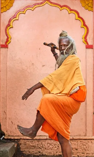 A Hindu holy man dances outside a temple during Kumbh Mela, or Pitcher festival, August 28, 2015,at Trimbakeshwar, India. (Photo by Rajanish Kakade/AP Photo)