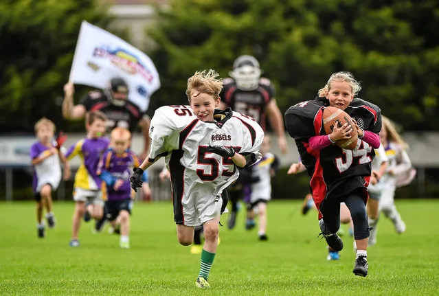 Ahead of the Croke Park Classic on August 30th, 2014, the Dublin Rebels gave an American Football demonstration to kids taking part in the Kilmacud Crokes GAA Camp. Pictured during an American football demonstration at Kilmacud Crokes GAA Camp is Andrew Blanaker, aged 6, from Mount Merrion, Dublin, left, and Clara Corincan, aged 7, from Deansgrange, Dublin. (Photo by Ramsey Cardy/SportsFile)