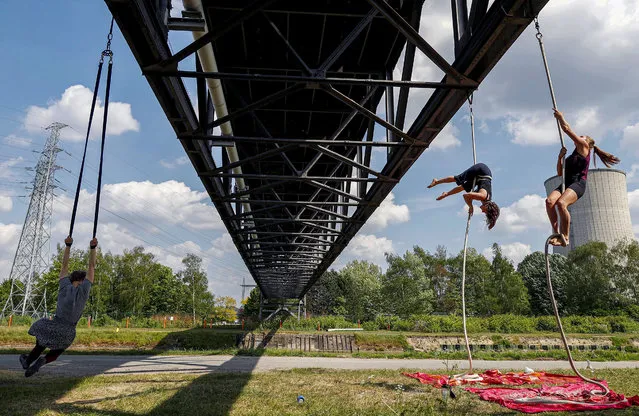 Students from a closed Brussels' circus school hang on ropes attached to an abandoned bridge during the lockdown imposed by the Belgian government to slow down the coronavirus disease (COVID-19) spread, Belgium on April 27, 2020. (Photo by Francois Lenoir/Reuters)
